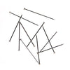 A collection of mild steel straight pins scattered on a white surface.