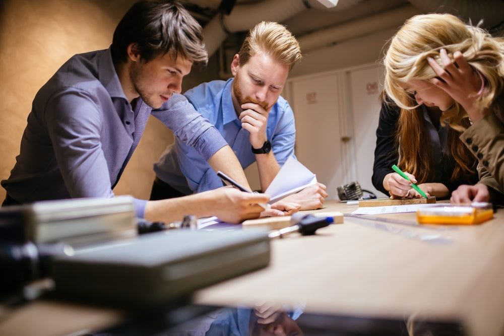 a group of people are brainstorming creative ideas around hook and loop and other workroom tools